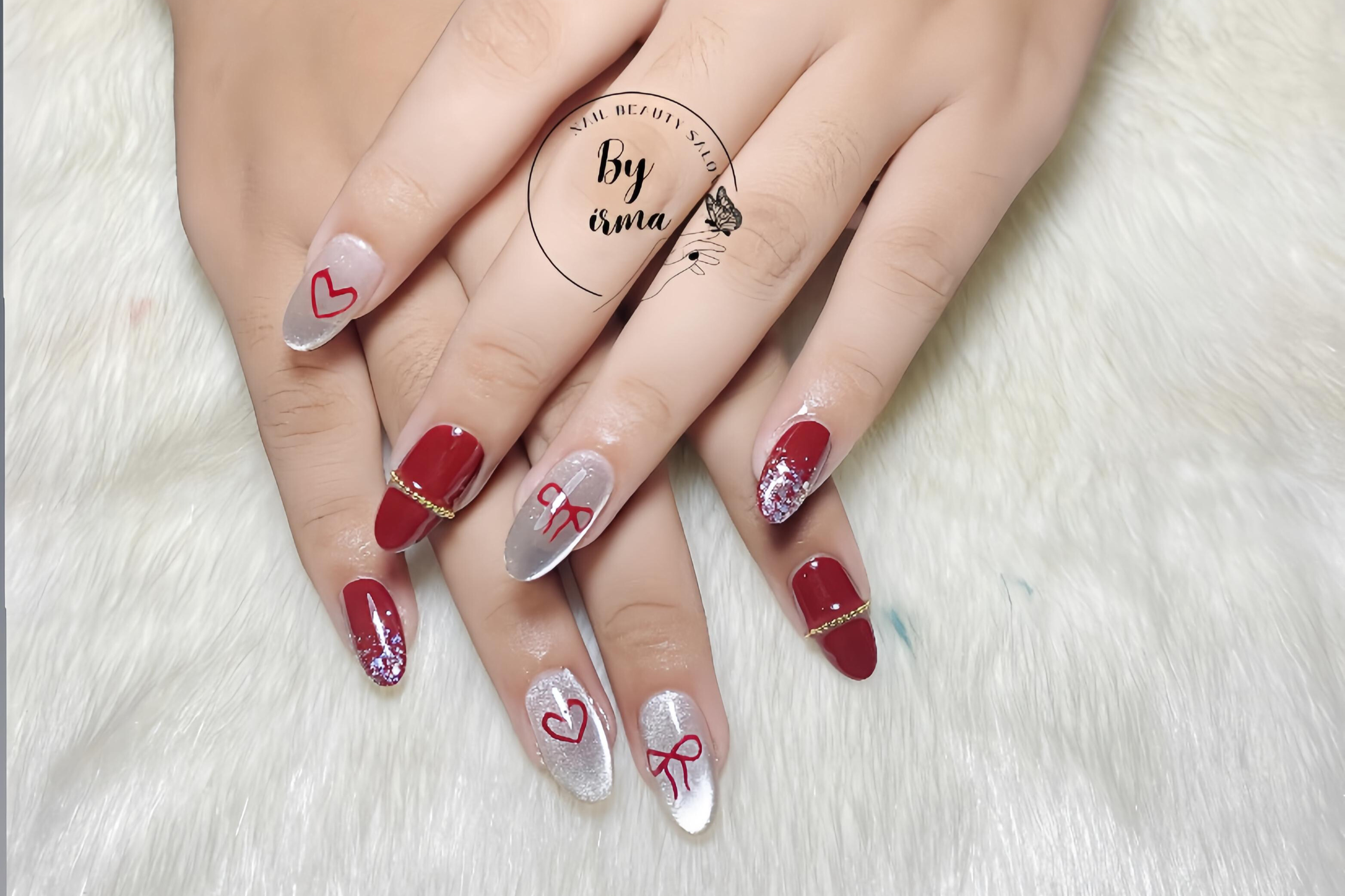 Acrylic nails with intricate 3D floral decoration and rhinestones